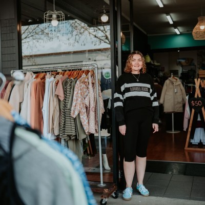 Lady standing outside a clothing shop